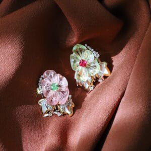 A custom-made pair of earrings with yin-yang tourmaline carvings accented with mint garnet and vivid pink spinel cushions