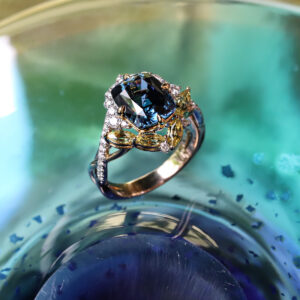Intricate craftsmanship in our unique rings. Bespoke blue spinel ring with yellow sapphires and diamonds