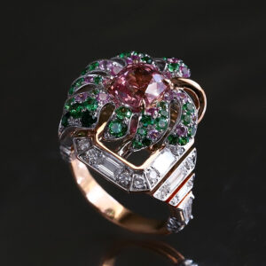 A magnificent bespoke creation inspired by monstera leaves, featuring a pink spinel combined with tsavorites and sapphires.