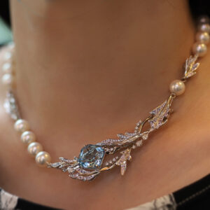 A one-of-a-kind bespoke creation, featuring an aquamarine, pearls, and diamonds, which can be worn as a brooch as well.