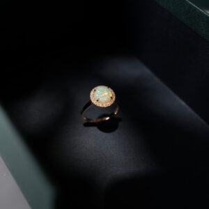 Custom opal engagement ring with diamond halo.