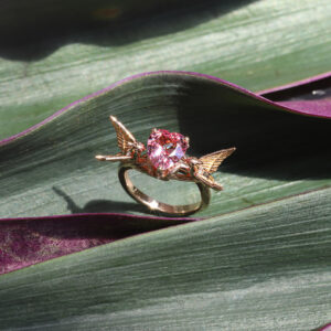 custom engagement ring with a heart-shaped pink spinel and pair of birds