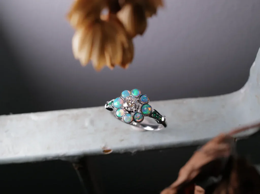 A ring of Australian opals around a diamond centrestone