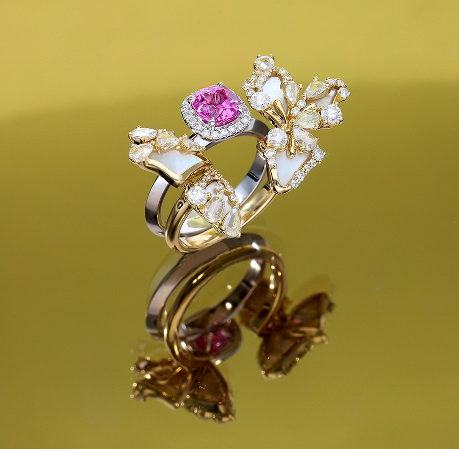 Butterfly jackets adding a dramatic flair to a sapphire stack ring