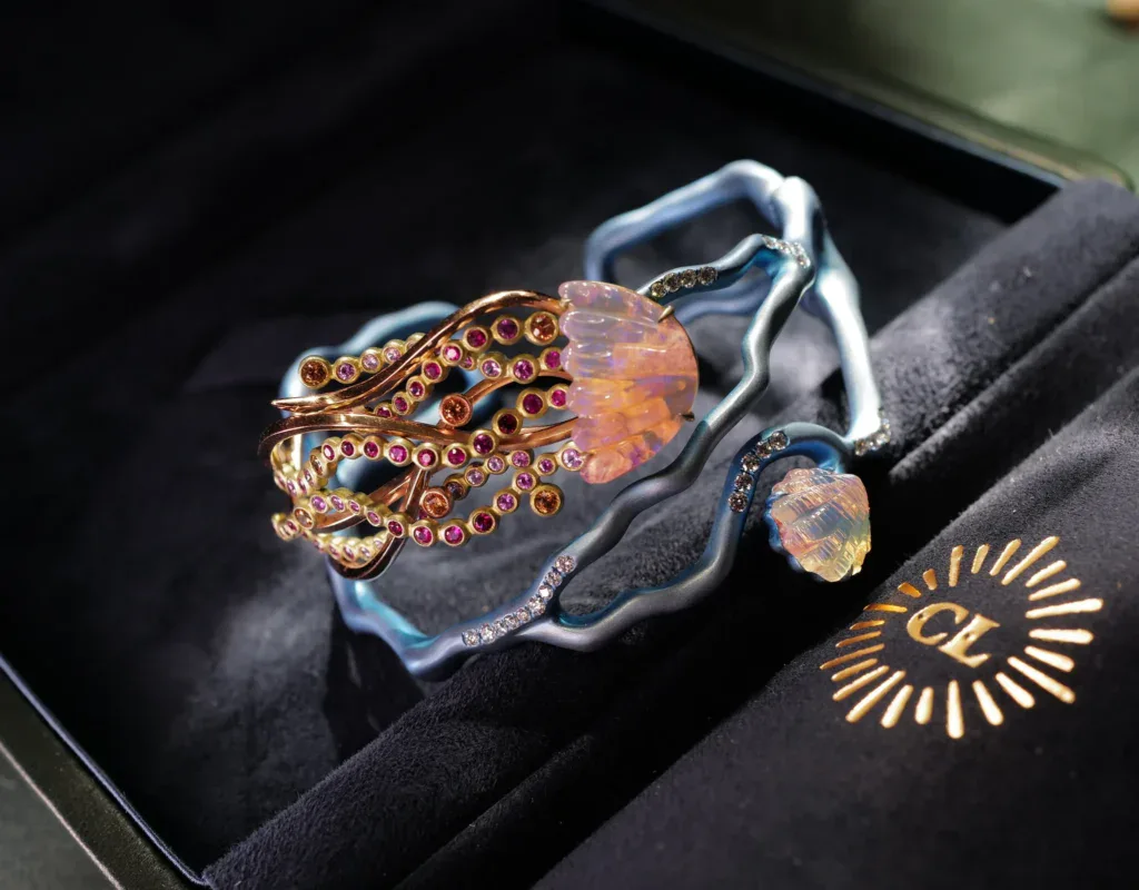 Coral reef cuff – titanium cuff cradling an opal jellyfish and shell