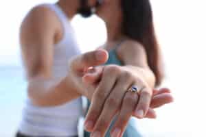 Couple showcasing a gemstone engagement ring during engagement, featuring a customised engagement ring by Calla Lily in Singapore.
