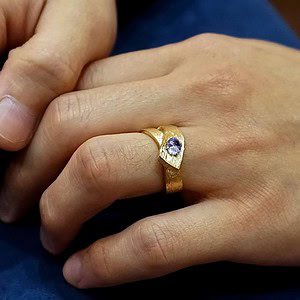 Bespoke men's cobalt blue spinel ring with a textured branch-like effect and asymmetrical style.