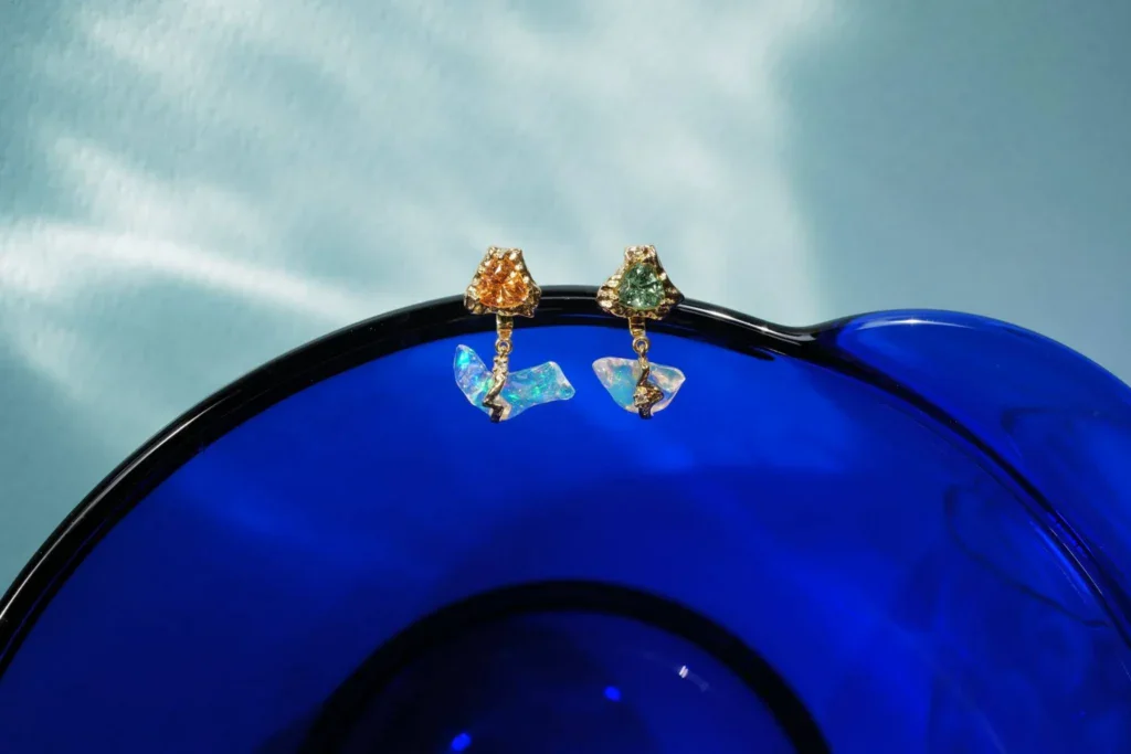 We designed these yin yang earrings around the water opals which fell along the curvature of our client's ear perfectly. They resembled little clouds, so we added a thunderbolt fixture striking through them
